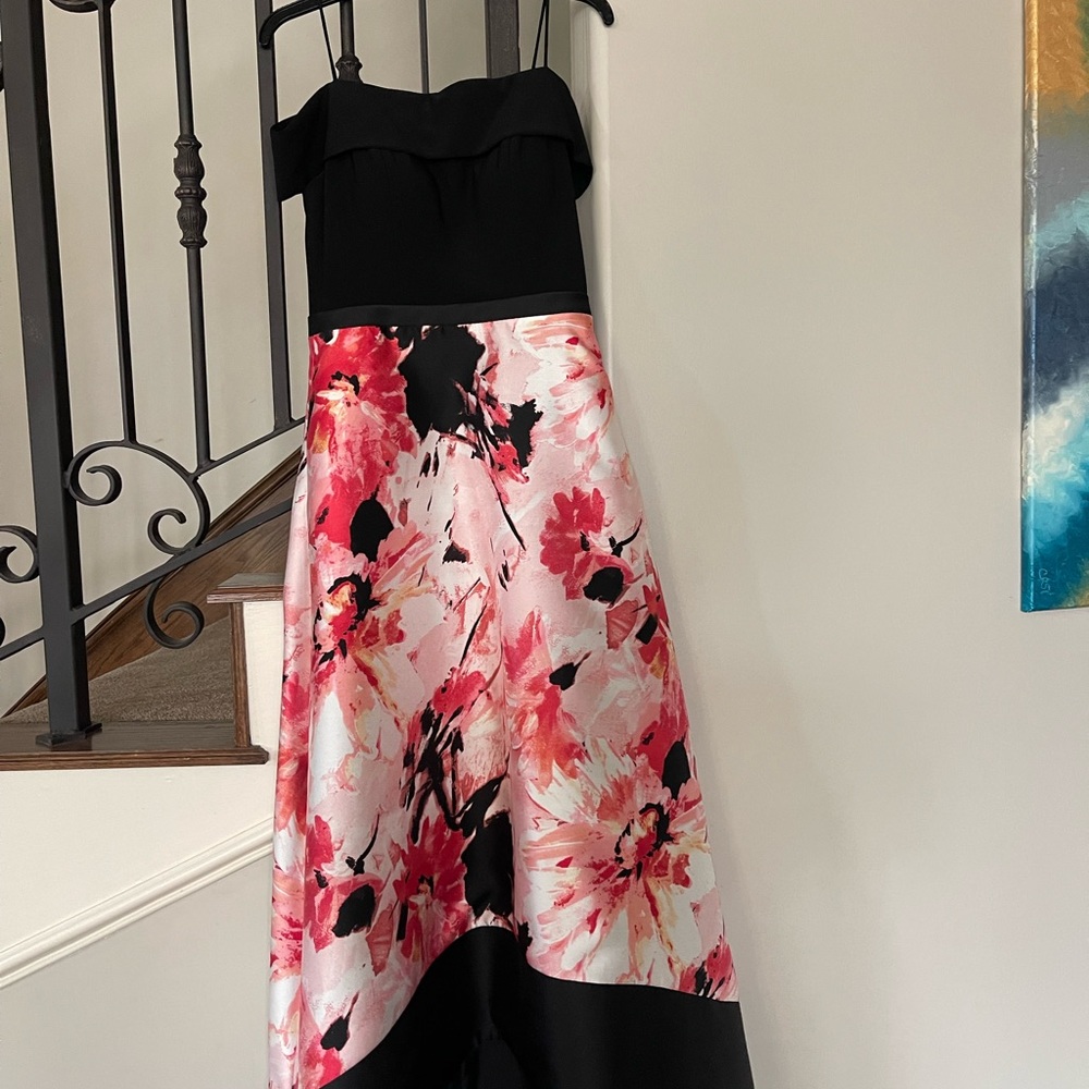 Black off the shoulder gown with floral high low skirt.